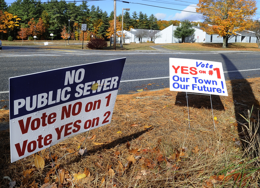 With North Yarmouth Memorial School in the background, a pair of competing signs demonstrate the split in opinions on referendums the town faces on Tuesday.
(Gordon Chibroski/Staff Photographer)