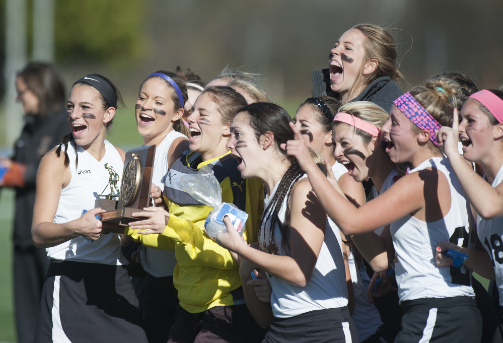 The Skowhegan girls’ field hockey team celebrates a 3-1 win over Thornton Academy in the state Class A final on Saturday in Orono.