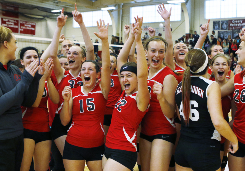 The Scarborough High volleyball team celebrates its victory over Greely in the state Class A final Saturday in South Portland.