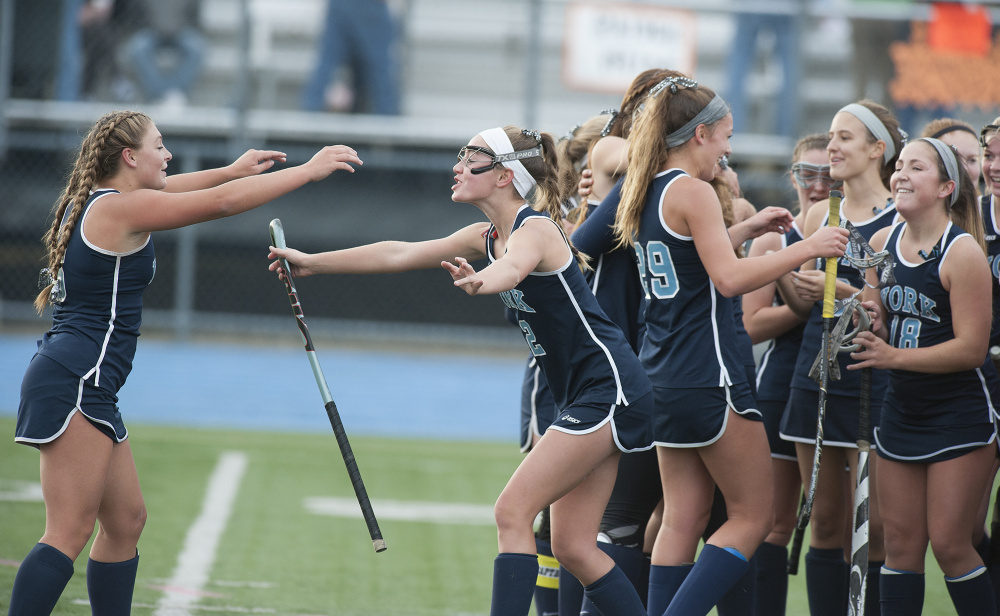 Members of the York girls field hockey team celebrate their 3-2 win over Winslow at the Class B field hockey state championship on Saturday in Orono. The Wildcats have won back-to-back state championships. 
Kevin Bennett photo