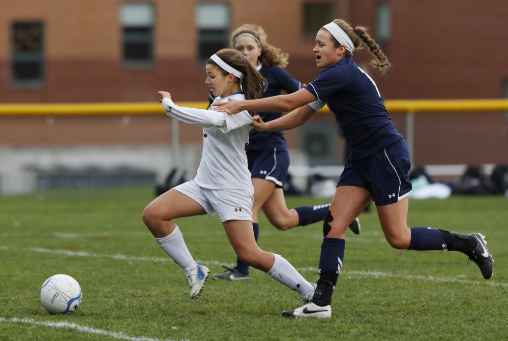Greely’s Ellie Schad dribbles through defenders while being pursued by Yarmouth’s Lilly Watson, right, during the first half of their Class B South semifinal Saturday in Cumberland. Schad scored on the play and Greely won, 2-1, to advance to the regional final. 
 Joel Page/Staff Photographer