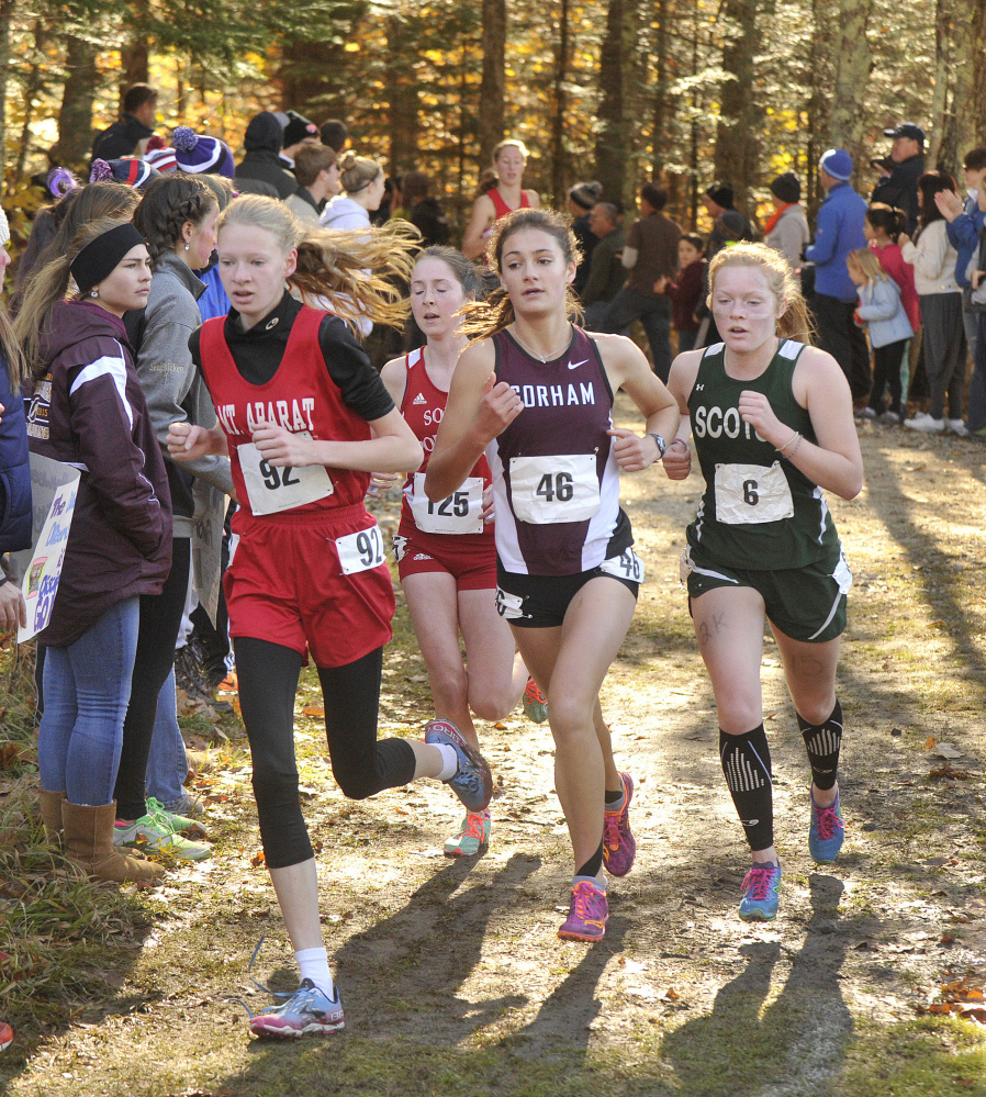 Anna Slager of Gorham, 46, prepares to emerge from the lead pack and claim the Class A cross country championship Saturday. Challenging were, left to right, Katherine Leckbee of Mt. Ararat, Serena McKenzie of South Portland and Kialeigh Marston of Bonny Eagle.