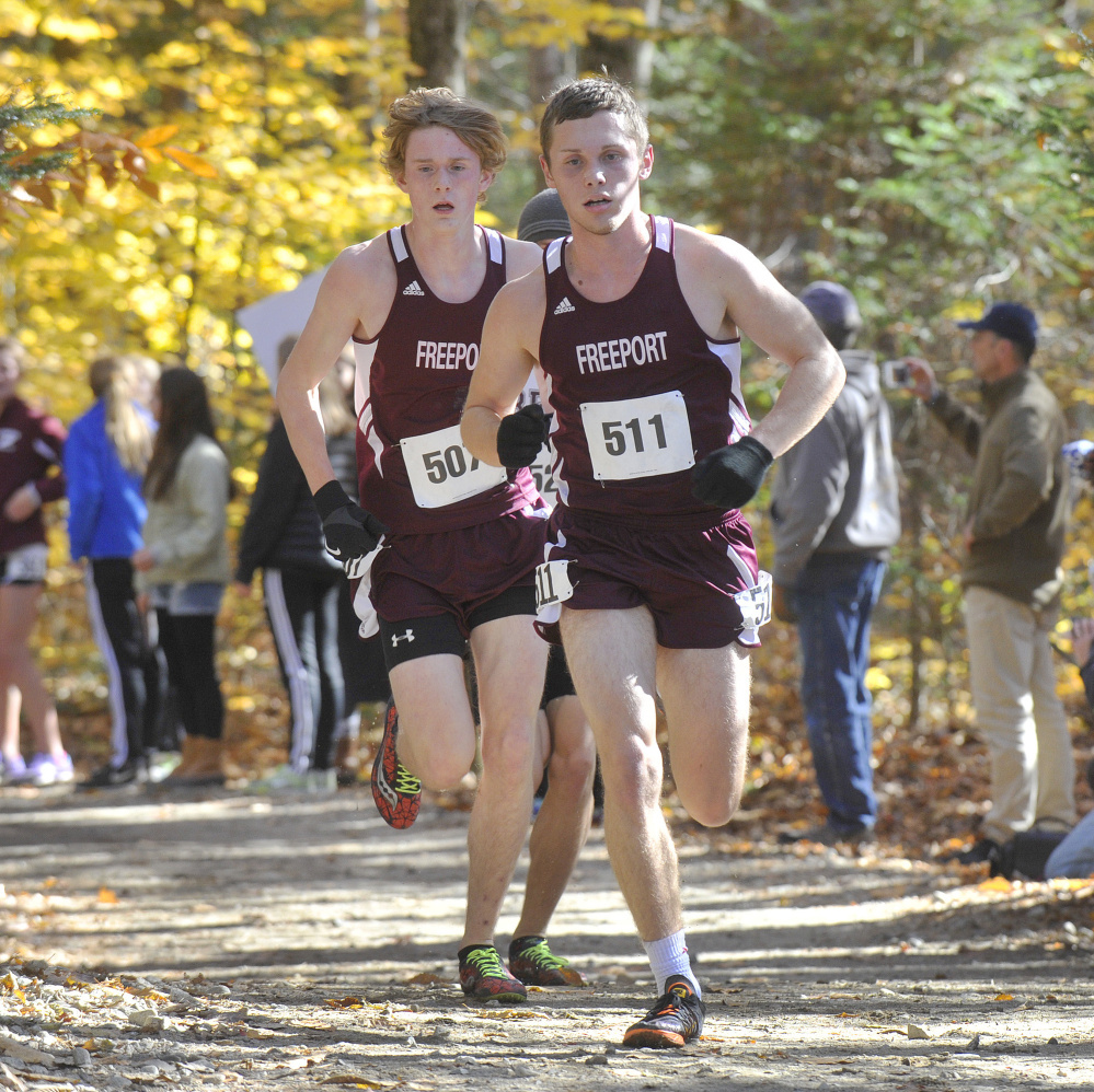 Chandler Vincent, 511, and his Freeport teammate, Henry Jaques, lead the field while leading the Falcons to a second straight Class B state title Saturday at Cumberland. Vincent covered 5 kilometers in 16 minutes, 34 seconds.
