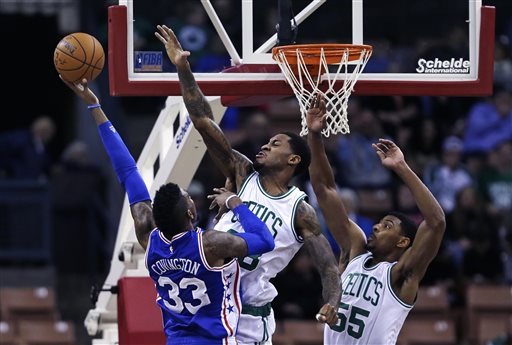 Philadelphia 76ers forward Robert Covington is fouled by Boston Celtics forward Perry Jones, center, while driving to the basket in the second half of Friday's preseason game in Manchester, N.H. The Associated Press
