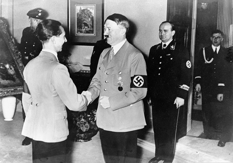 1937: German Chancellor Adolf Hitler, right, congratulates Dr. Joseph Goebbels on his 40th birthday at the ministry of propaganda and public enlightenment in Berlin.