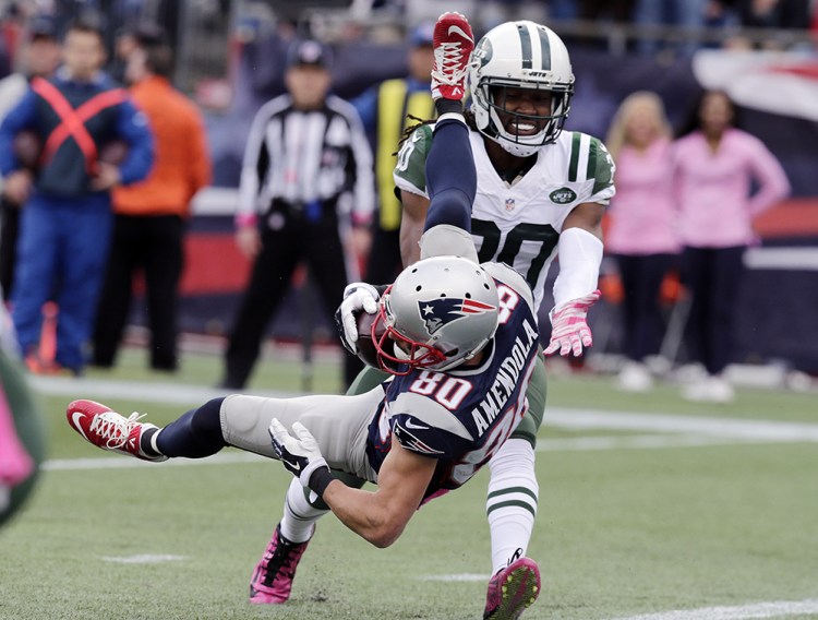 New England Patriots wide receiver Danny Amendola (80) scores a touchdown after catching a pass in front of New York Jets cornerback Marcus Williams (20) in the second half Sunday in Foxborough, Mass. The Associated Press
