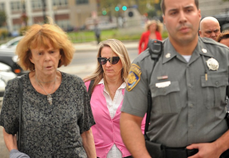Jennifer Connell, center, is escorted to her car by marshals Tuesday after a jury ruled that her nephew was not liable for  injuries she suffered when he greeted her enthusiastically at his 8th birthday party four years ago. Brian A. Pounds/Hearst Connecticut Media via AP