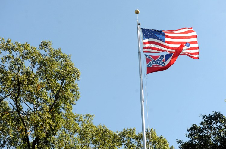 In a October 16, 2015 photo, the Mississippi state flag and U.S. flag fly in the Circle on campus at the University of Mississippi in Oxford, Miss. The state flag was removed Monday, Oct, 26, 2015, days after the student senate, the faculty senate and other groups adopted a student-led resolution calling for removal of the banner from campus.  (Bruce Newman/Oxford Eagle via AP)