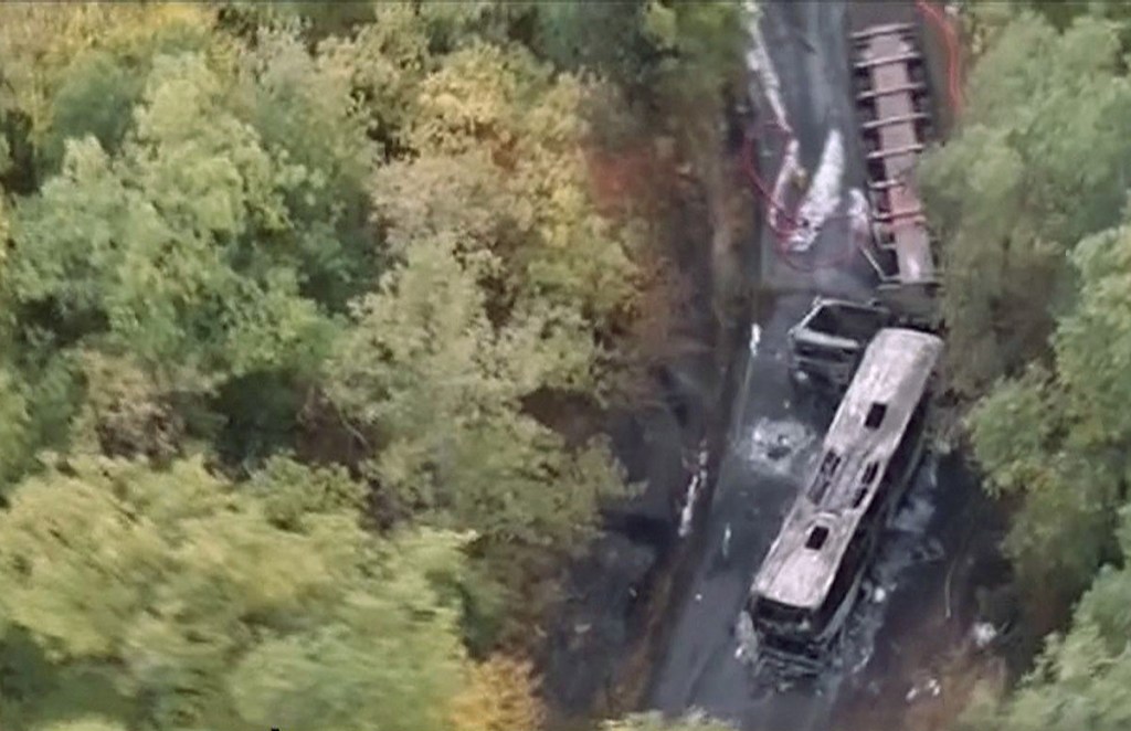 This image taken from video shows the scene after a truck and a bus transporting retirees on a day trip collided and caught fire Friday in southwest France, killing 43 people. Télé FRANCE TV via AP