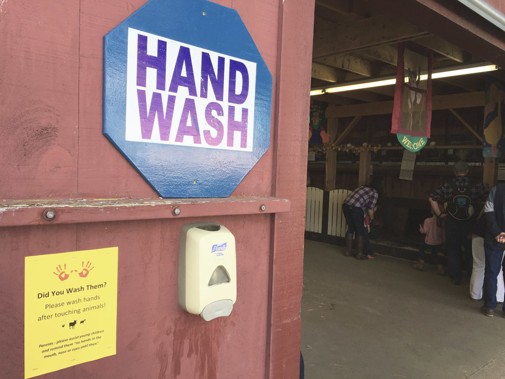 A hand-washing station is mounted outside a barn at the Old McDonald's Farm petting zoo at the Fryeburg Fair on Wednesday.