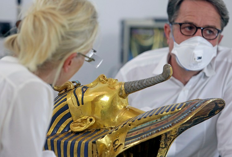 German restorers Christian Eckmann, right, and Katja Broschat examine the golden mask of King Tutankhamun at the Egyptian Museum in Cairo. The 3,300-year-old mask was discovered in Tutankhamun's tomb along with other artifacts by British archaeologists in 1922. The Associated Press