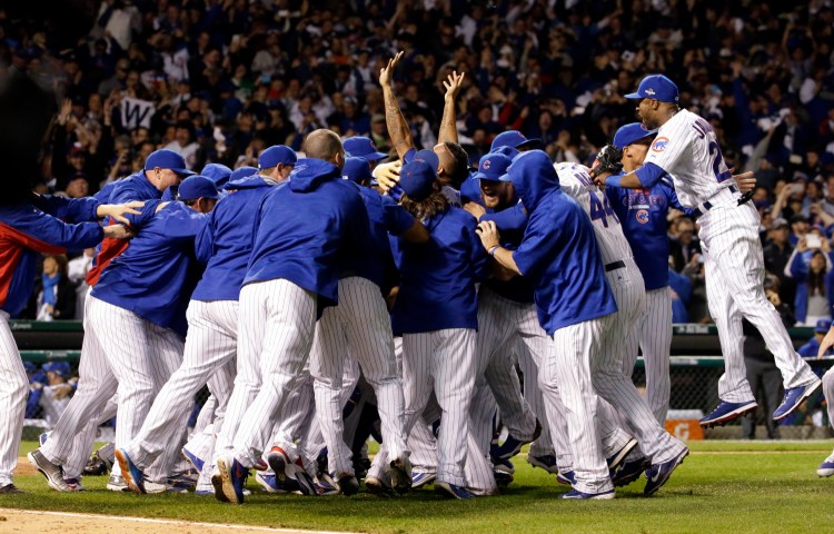 The Cubs celebrate their four-game victory over the St. Louis Cardinals in the National League Division Series on Tuesday night in Chicago.