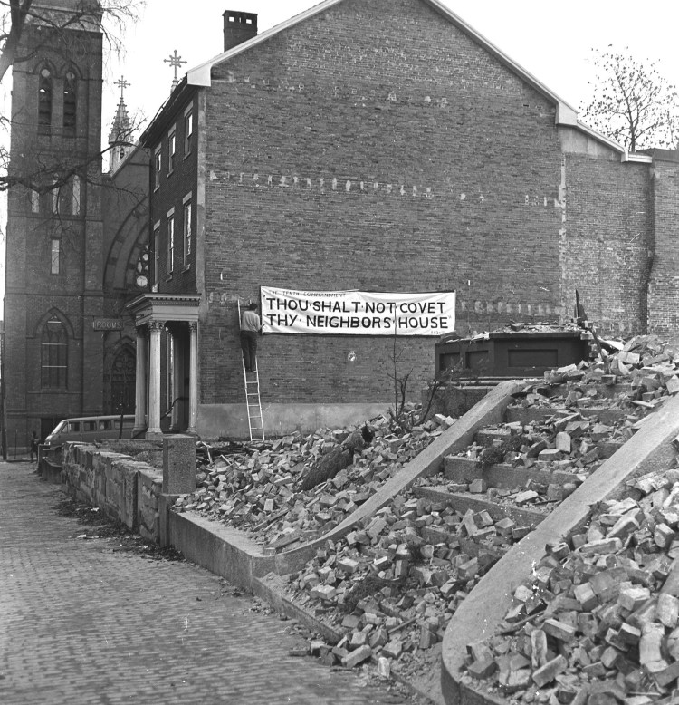 A rooming house tenant protests urban renewal plans near the corner of State Street and Gray Street in December 1970. 