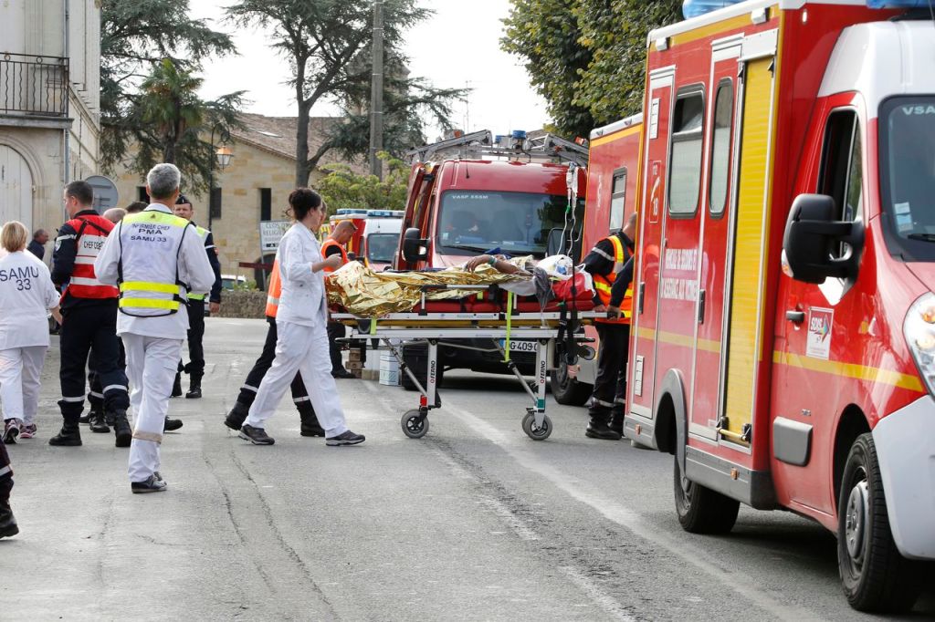 Rescue workers carry an injured person on a stretcher during rescue operations near the site where a tour bus carrying retirees collided with a truck outside Puisseguin near Bordeaux, western France, Friday. Reuters