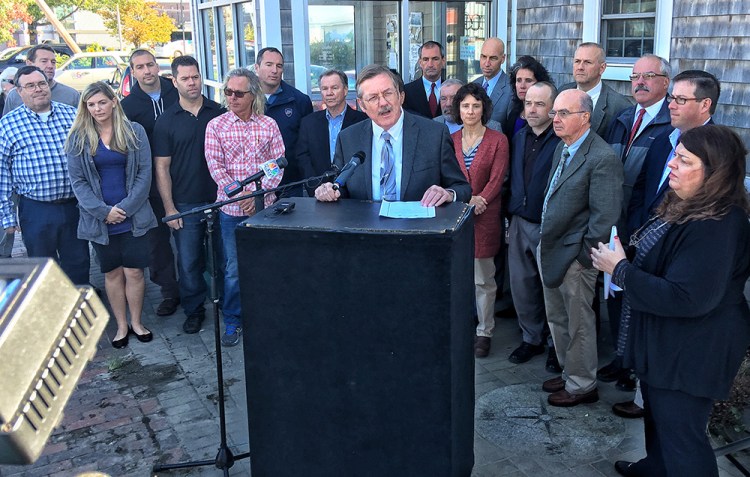 Chris Hall, CEO of the Portland Regional Chamber, speaks Wednesday at a news conference outside Becky's Diner. He asked people to vote no on a referendum that would raise the city's minimum wage to $15 an hour. Gordon Chibroski / Staff Photographer