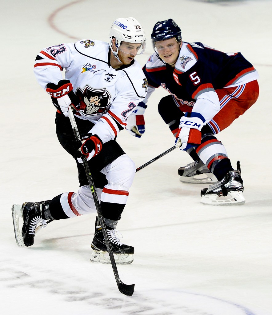 Connor Brickley of the Portland Pirates takes the puck down the ice as Tommy Hughes of the Hartford Wolf Pack attempts to contain him. The teams meet again Friday night in Portland. Shawn Patrick Ouellette/Staff Photographer