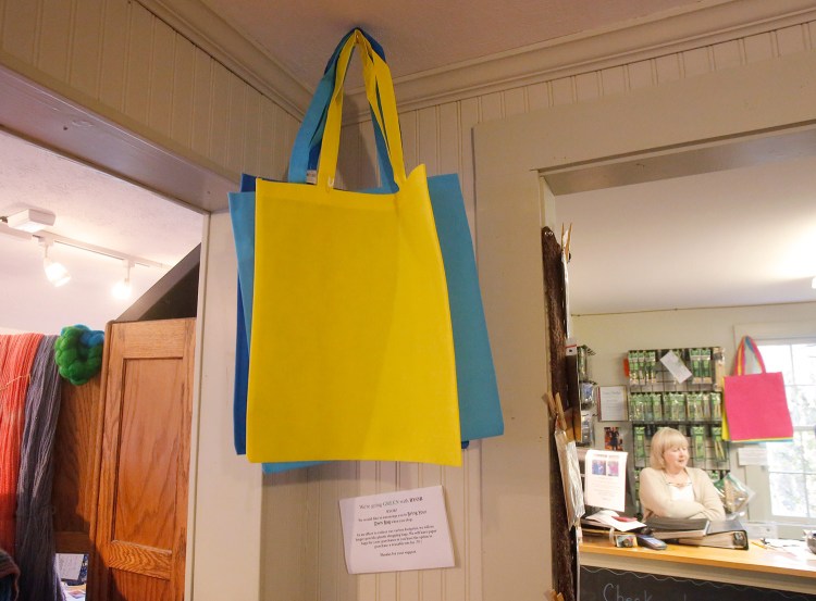 Reusable bags are offered for sale at The Yarn Sellar in York. York voters on Tuesday approved a ban on plastic bags, the first outright ban of single use bags in Maine. The Yarn Sellar stopped using plastic bags earlier this year. 