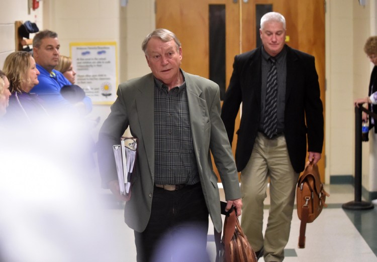 Eric Haley, superintendent of Waterville schools, and Assistant Superintendent Peter Thibotot, back, leave the final school board executive session of the night Wednesday at George J. Mitchell School in Waterville.