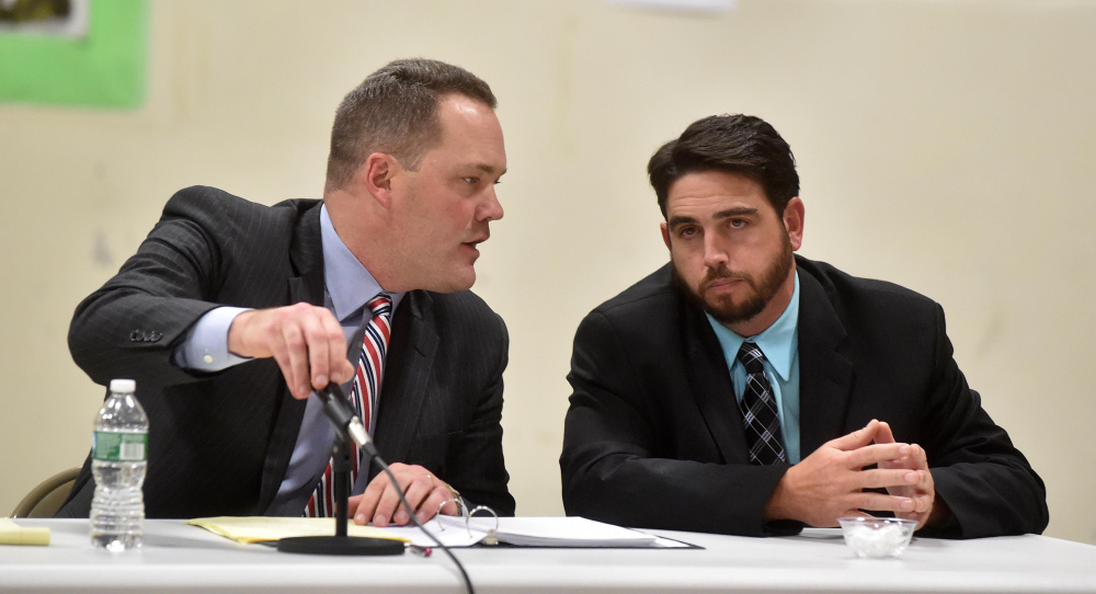 Gregg Frame, left, confers with his client, Waterville Senior High School Principal Don Reiter, during Wednesday's hearing with the Waterville school board at George J. Mitchell School in Waterville.