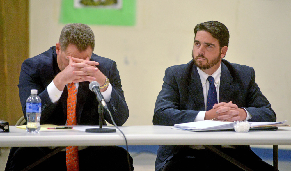 Don Reiter, right, former Waterville Senior High School principal, listens during a public hearing at the George J. Mitchell School in Waterville on Nov. 10. The Waterville Board of Education on Monday voted to dismiss Reiter as principal and the Kennebec County District Attorney’s Office plans to announce Thursday whether criminal charges will be brought against him.