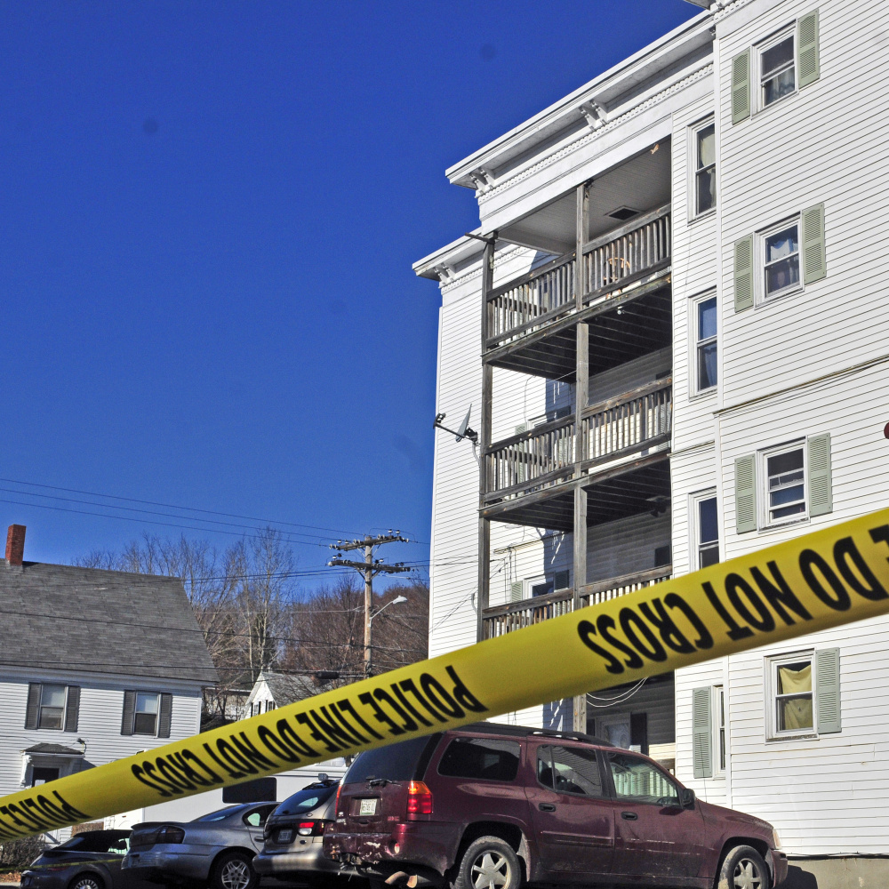 Police tape surrounds the parking lot at 75 Washington St. on Tuesday in Augusta, where police say 31-year-old Joseph Marceau was killed Monday night.