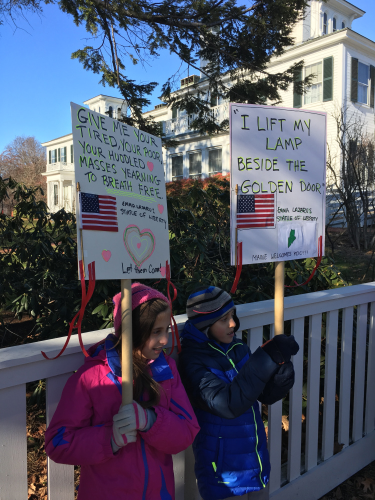 Ava and Noah Katz, 10-year-old twins from Hallowell, participated in Wednesday’s vigil in support of Syrian refugees held outside the Blaine House in Augusta.