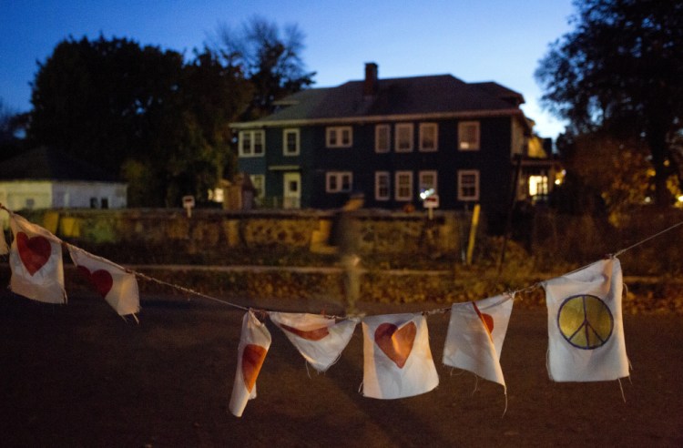 A string of flags with hearts and peace signs serves as a memorial last October marking the first anniversary of the fire on Noyes Street in Portland that killed six people in their 20s. The second Stars of Light memorial service is planned Sunday. 