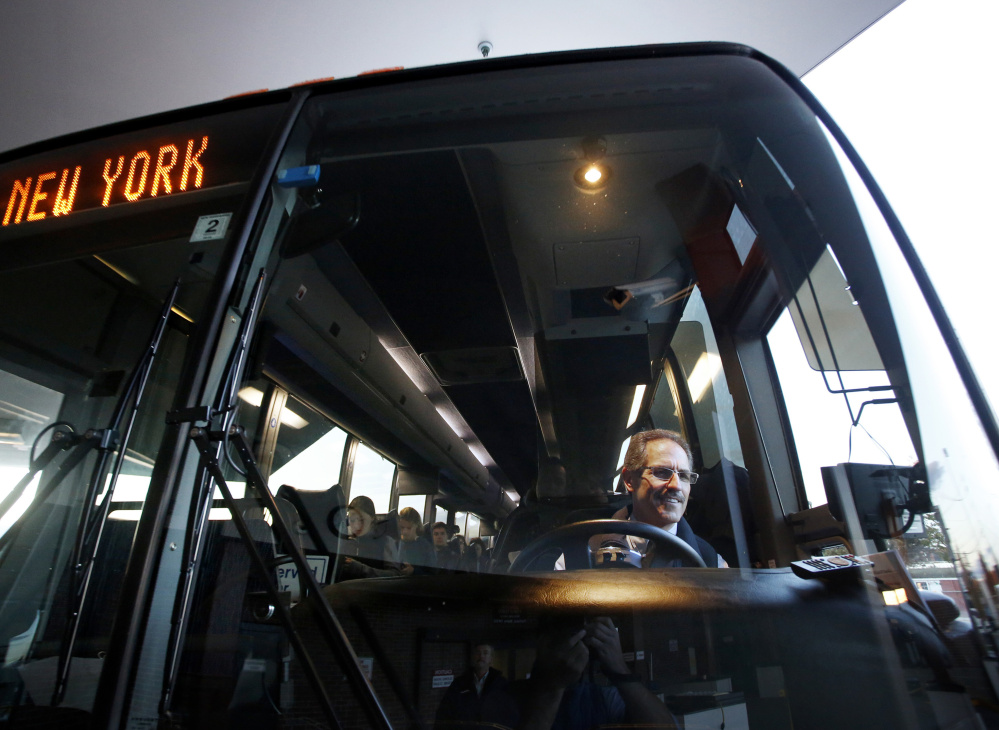 Concord Coach Lines made it first direct bus trip from Portland to New York City on Monday. Driver Roger Dubay checks his mirrors before departing from the transportation center in Portland.