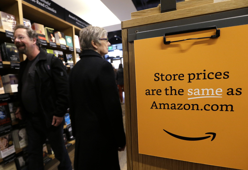 Customers shop at the opening day for Amazon Books, the online retailer’s first on-the-ground store in Seattle on Tuesday – two decades after the company began selling books on the Internet. The company did not say if it would open other stores in the future.