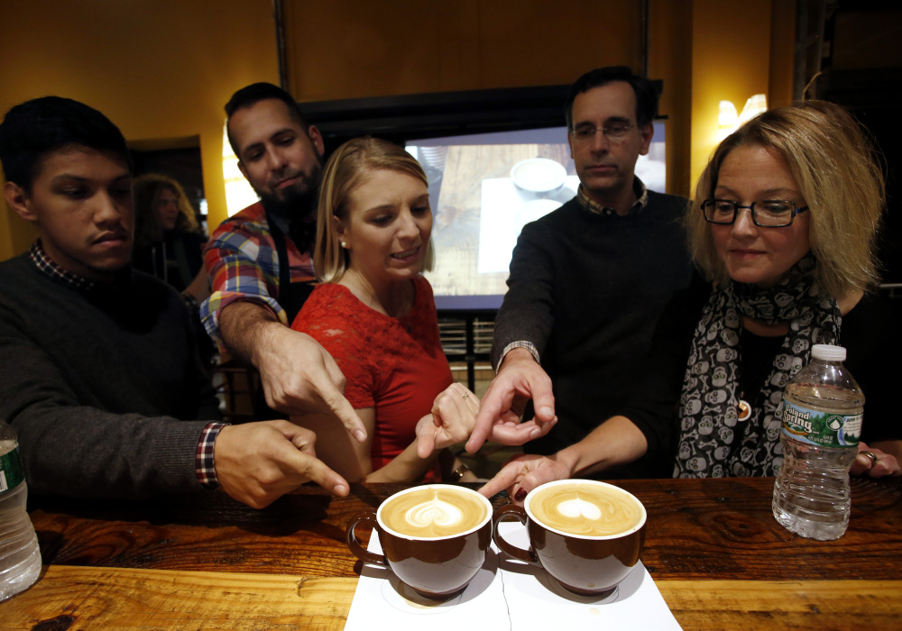 The judges point to their favorites during a baristas competition  at Coffee By Design in Portland. From left are: Michael Acosta, a barista at J. Rene Coffee Roasters in West Hartford, Conn.;  Jesus Gomez, the head barista at J. Rene Coffee Roasters; Jana Barnello, anchor of "Good Day Maine;" Anestes Fotiades, founder of Portland Food Map; and Kathleen Pierce, a journalist and food blogger.
Derek Davis/Staff Photographer