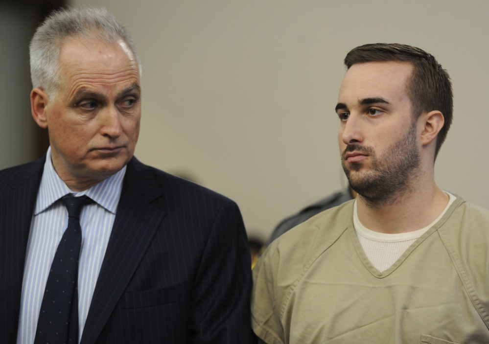 Kyle Navin, right, seen with his attorney, Eugene Riccio, is arraigned in Bridgeport Superior Court, in Bridgeport, Conn., on Tuesday. His parents went missing in August. Their remains were found Oct. 29 outside a vacant house in neighboring Weston.