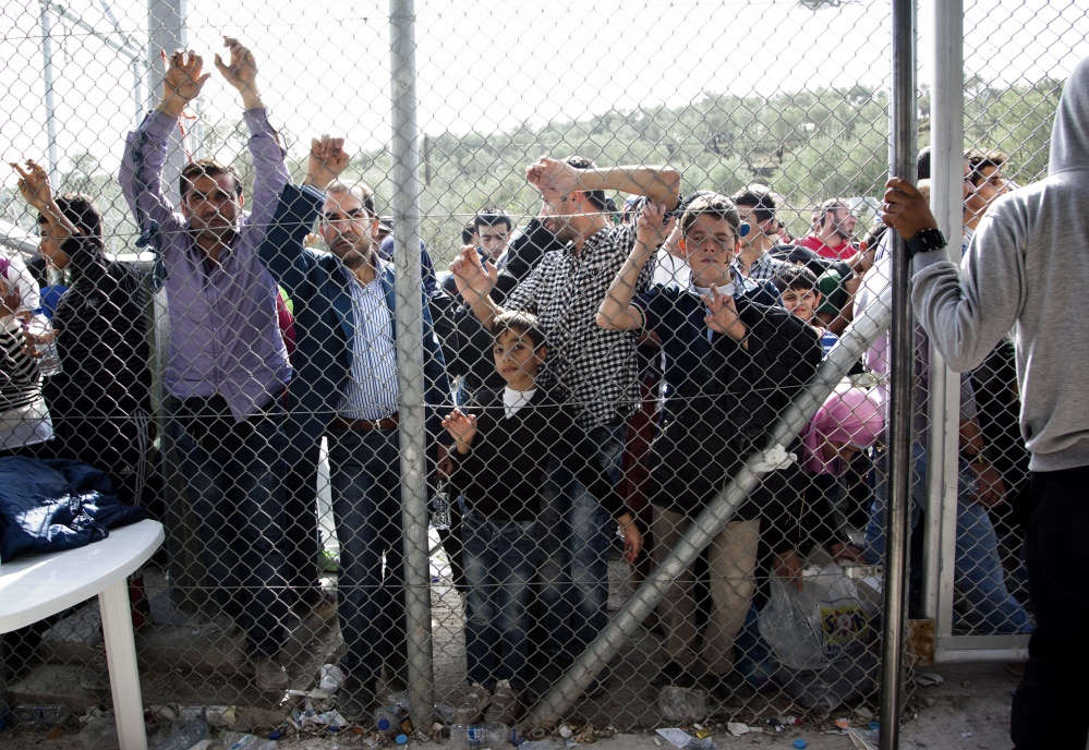 Migrants and refugees wait outside the Moria camp on the Greek island of Lesbos in October. Congress and many governors are putting pressure on the Obama administration to demonstrate that its screening process for refugees is adequate to protect Americans.
2015 Associated Press file photo