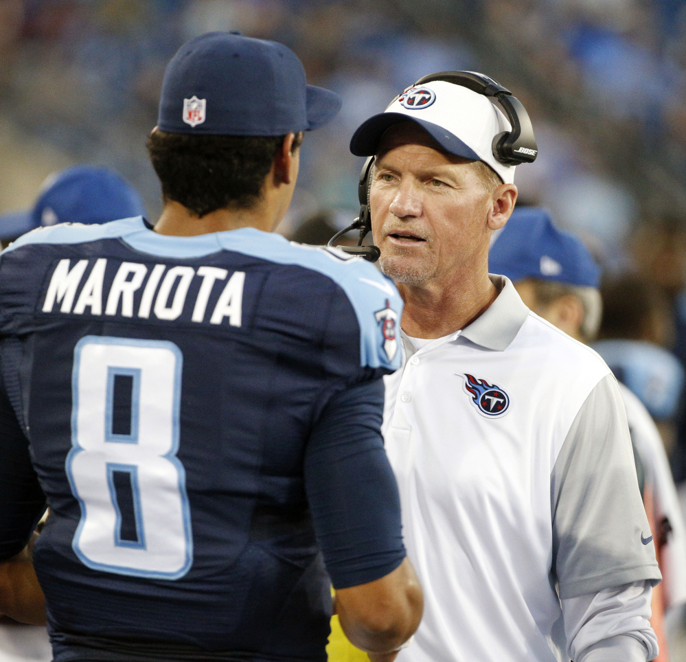 Tennessee Coach Ken Whisenhunt, seen talking with quarterback Marcus Mariota, was fired by the team after logging a dismal 3-20 record in less than two years on the job, including a 1-6 start this year. Mike Mularkey, a former head coach in Buffalo and Jacksonville, was named interim coach.
