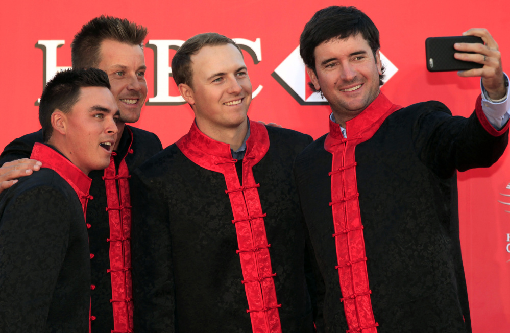 From left to right, golf players Rickie Fowler, Henrik Stenson,  Jordan Spieth and Bubba Watson, take a selfie during the HSBC Champions golf tournament photocall in Shanghai, China Tuesday, Nov. 3, 2015. (AP Photo)