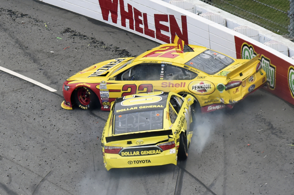 Joey Logano (22) and Matt Kenseth (20) tangle in Turn 1 during the NASCAR Sprint Cup Series auto race Sunday at Martinsville Speedway in Martinsville, Va.
The Associated Press