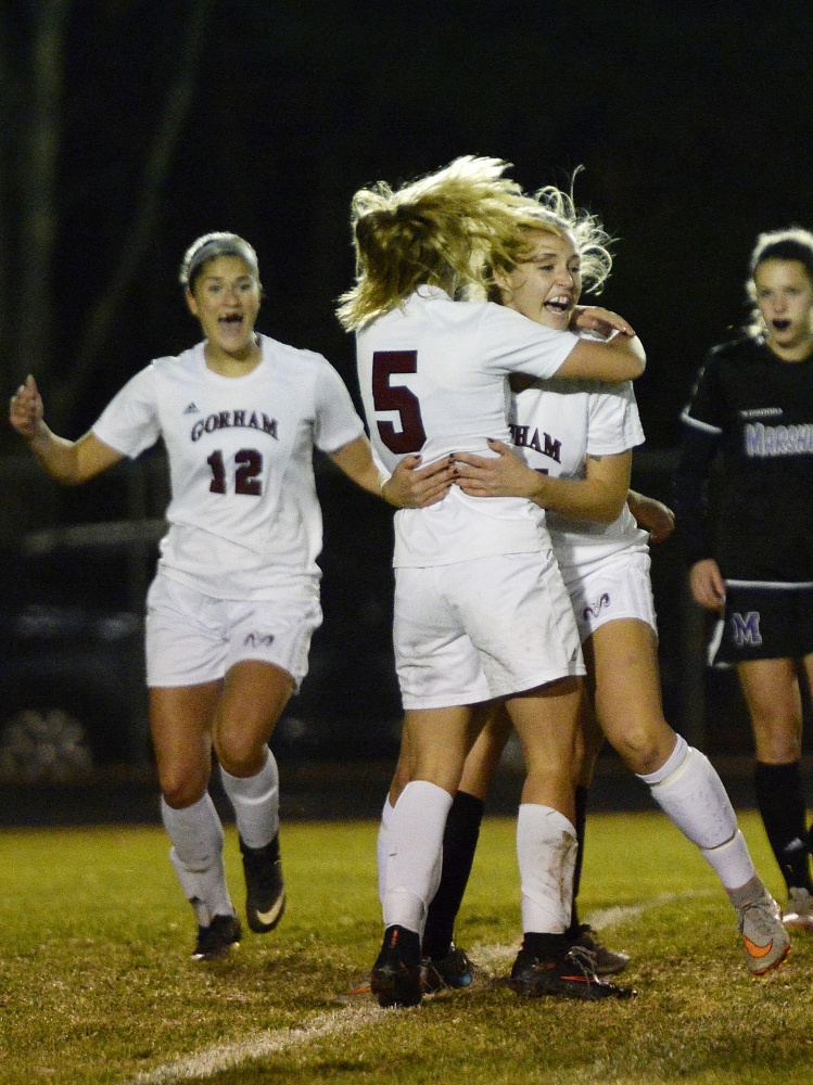 Gorham’s Emma Forgues, 5, is congratulated by Cady Houghton after scoring the first goal in a 4-0 win over Marshwood in the Class A South final Wednesday at Gorham.