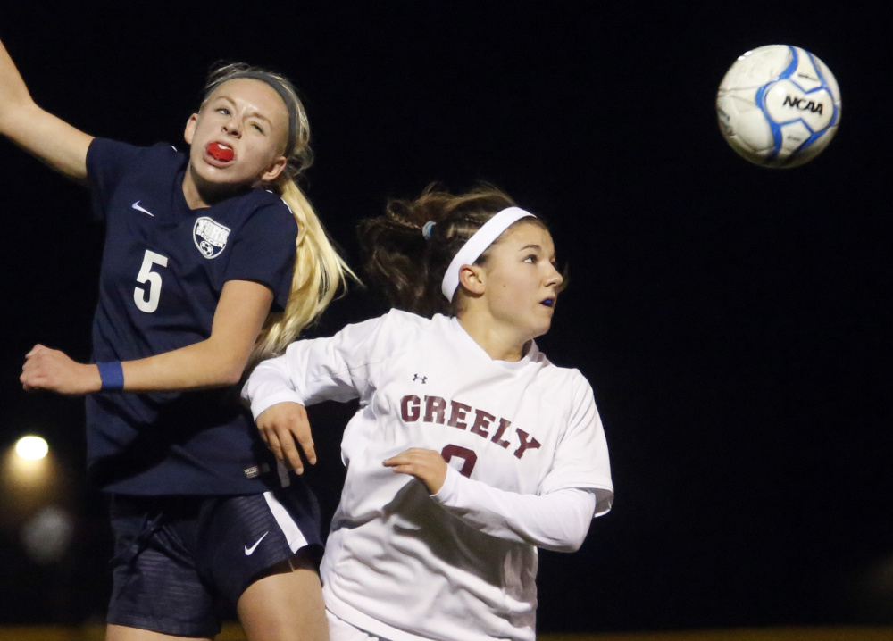 Ellie Bychok, left, of York and Ellie Schad of Greely vie for a header during the first half Wednesday night at Cumberland. The Rangers took a 2-0 lead in the first half. Derek Davis/Staff Photographer