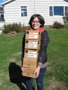 Suzanne MacDonald, community energy director at the Island Institute, delivers boxes of LED lightbulbs to a home on Matinicus Island.