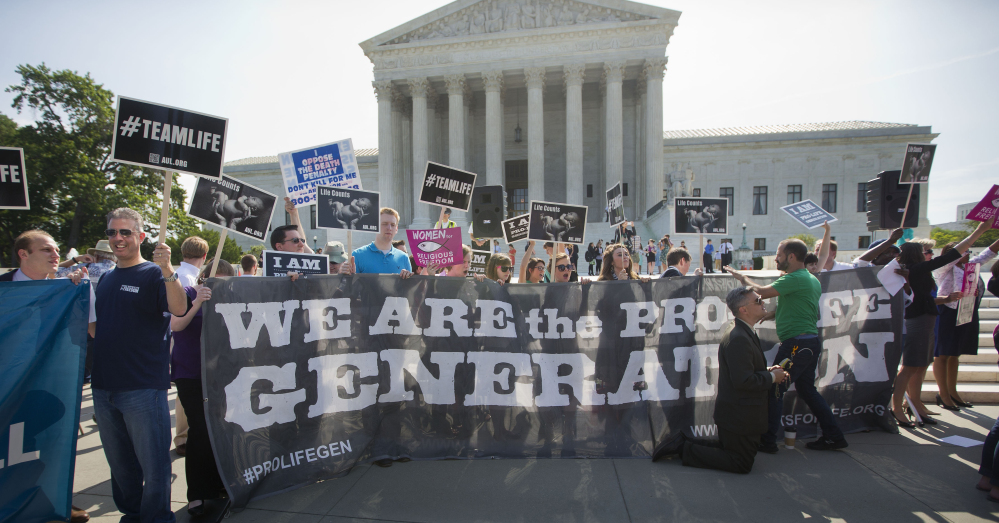 Pro-life demonstrators stand on the steps of the Supreme Court on June 30, 2014. In March, justices will consider another case tied to the health care act’s birth control provisions.