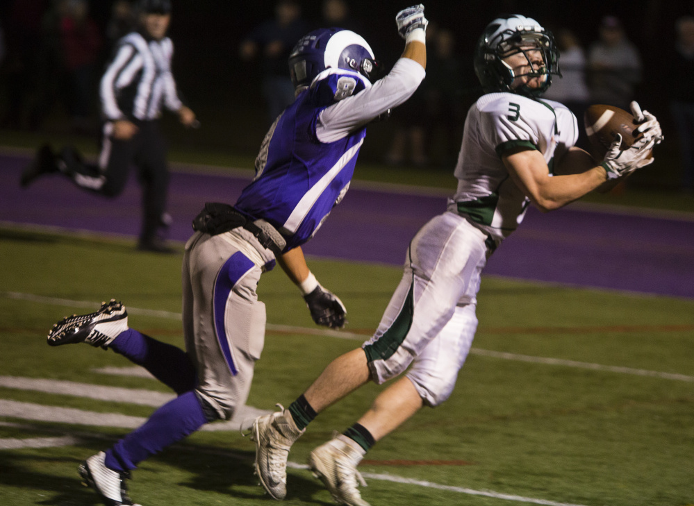 Bonny Eagle receiver Cam Theberge hauls in a pass against Deering cornerback Sambath Sao late in the first half Friday night in a Class A South semifinal at Deering High. Bonny Eagle couldn’t score, but the Scots shut out Deering in the second half and rallied for a 20-19 win.