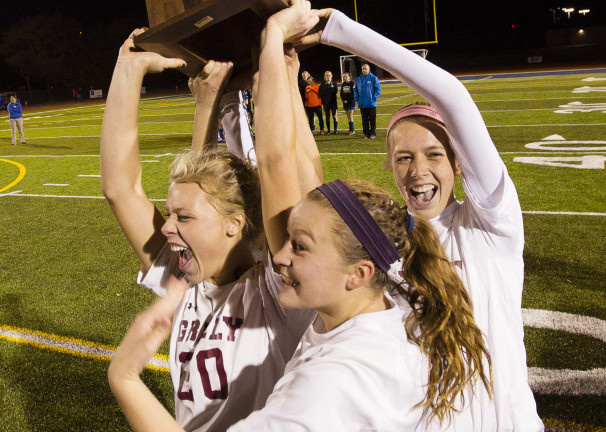 Greely’s Susannah Jacobson, Margaret Reed and Jocelyn Mitiguy lift the Gold Ball after the Rangers won the Class B state title Saturday at Fitzpatrick Stadium.
Carl D. Walsh/Staff Photographer