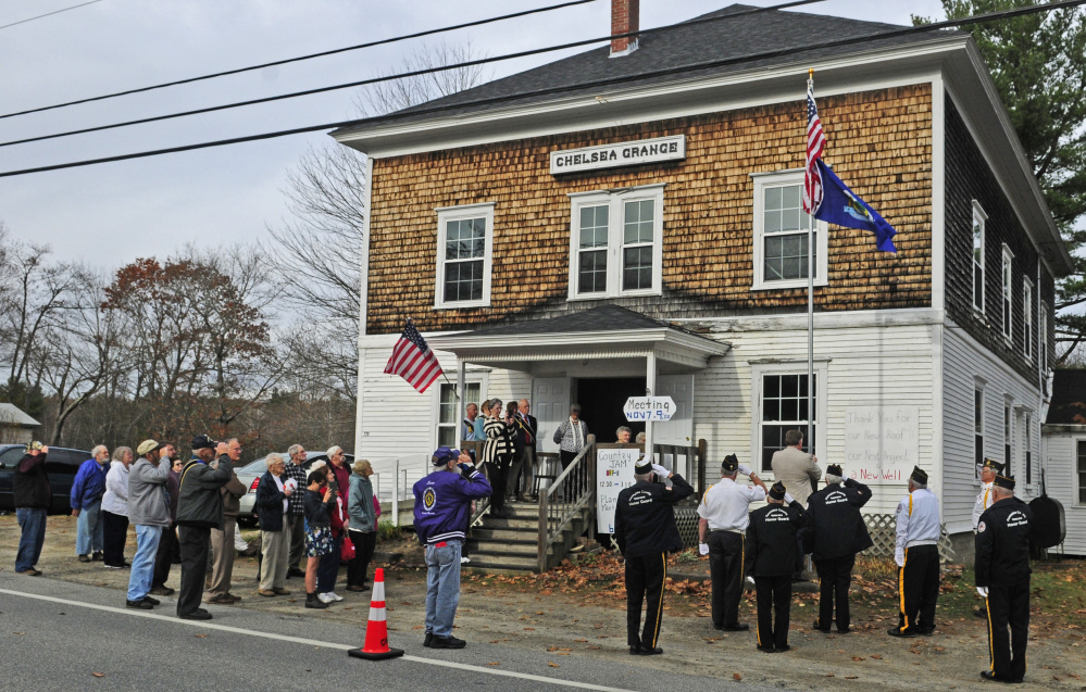 Attendees salute on Saturday during the dedication of a new flagpole at the Chelsea Grange hall.