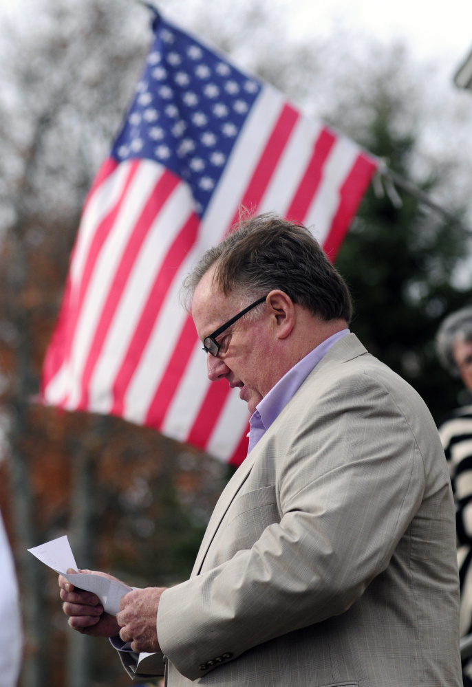 Tim Morgan reads a poem by Civil War soldier Charles Searls during the dedication of a new flagpole.