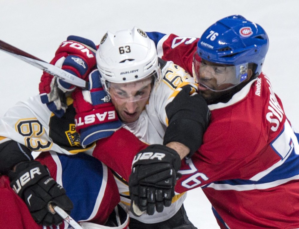 Canadiens defenseman P.K. Subban wraps up Boston’s Brad Marchand during Saturday’s game in Montreal. The Canadiens scored three goals in the third period to rally for a 4-2 win.