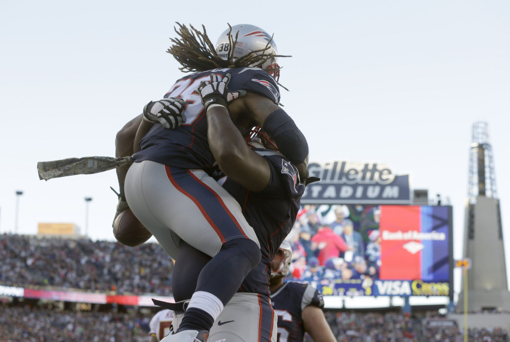 Patriots running back Brandon Bolden gets a lift after scoring a touchdown against Washington in the fourth quarter Sunday in Foxborough.