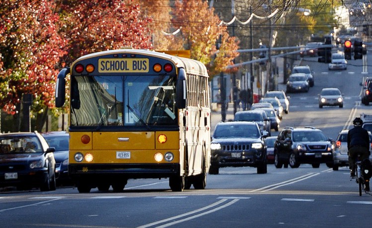 A school bus travels along Congress Street in Portland on Monday. The nation's top highway safety official says the agency will pursue a policy to require seat belts on school buses.