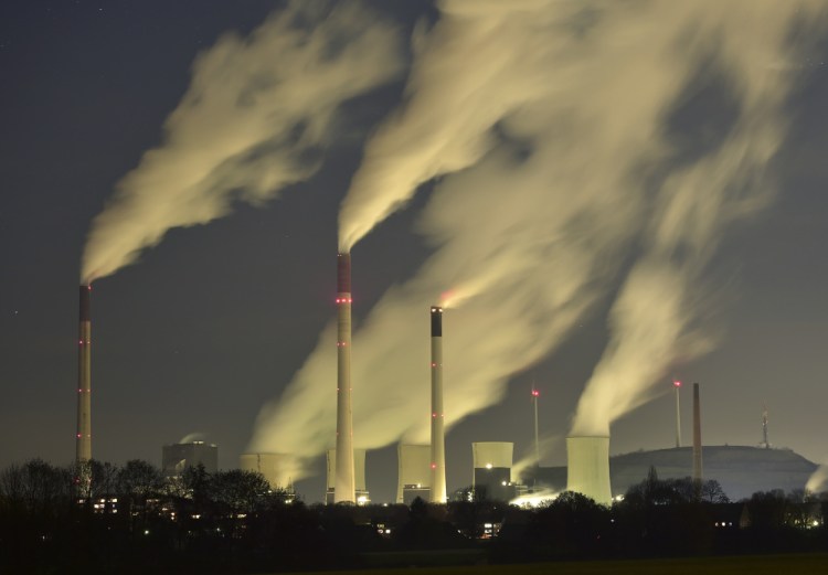 Smoke streams from the chimneys of a coal-fired power station in Gelsenkirchen, Germany. The U.N. weather agency says levels of carbon dioxide and methane, the two most important greenhouse gases, reached record highs last year.