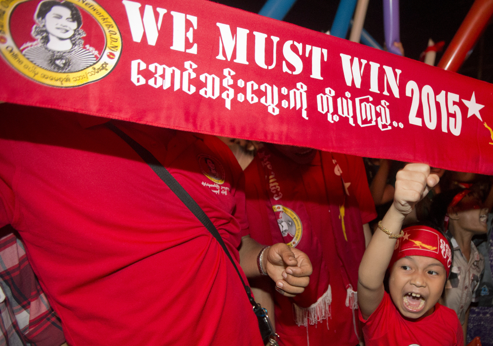 Supporters of Myanmar’s National League for Democracy party celebrate as election results are posted in Rangoon on Monday. Opposition leader Aung San Suu Kyi’s NLD party said Monday it was confident it was headed for victory.