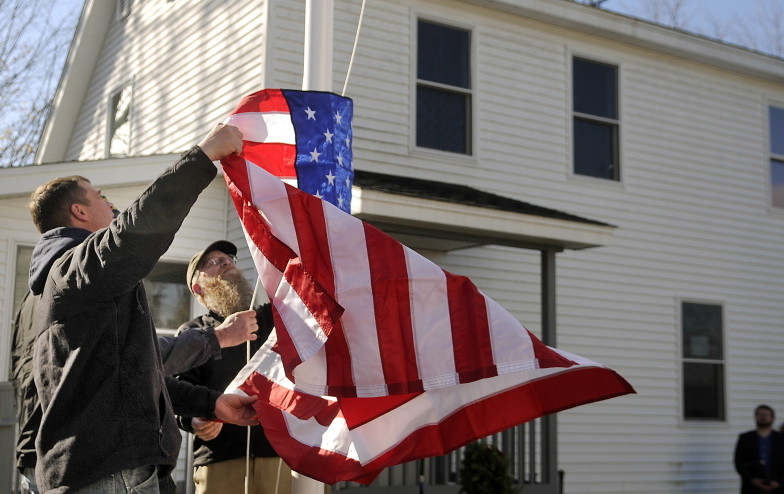 Residents of the Bread of Life Ministries Veterans Shelter in Augusta raise the flag there last Veterans Day. Shelters are essential, but to put an end to homelessness, policymakers must go much deeper.