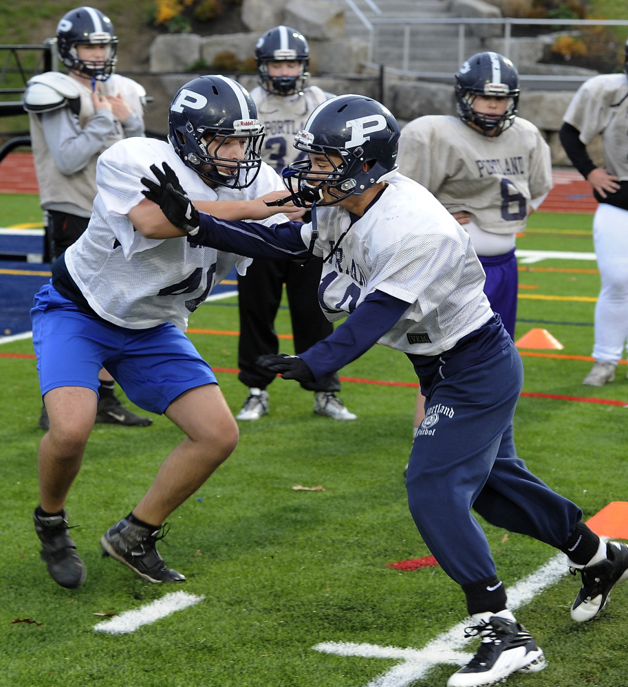 Nick Giaquinto, left, practices his offensive techniques with a defensive teammate. The Bulldogs graduated four offensive starters from a year ago, but recovered well.